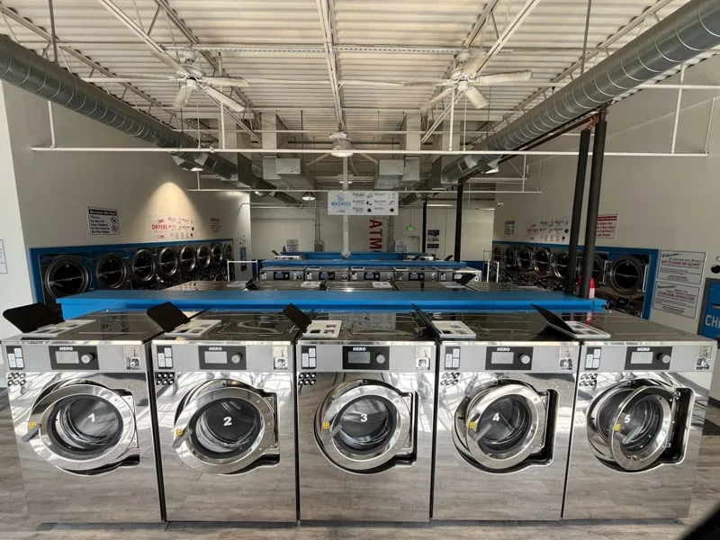 Large capacity commercial washers at Sandy Creek Laundromat for washing rugs